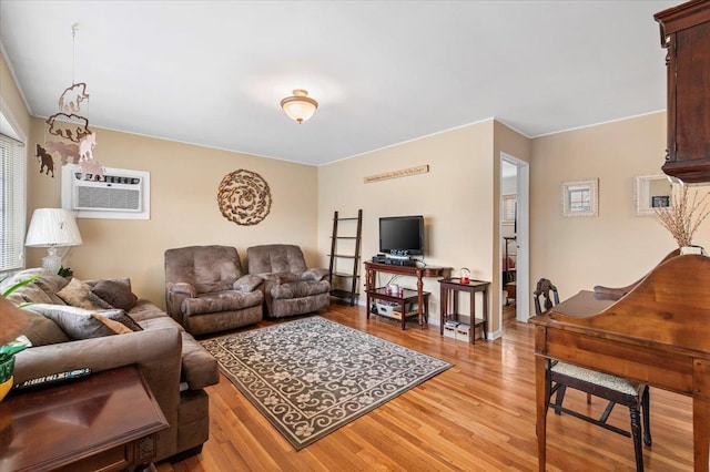 living room featuring an AC wall unit and light wood-style floors