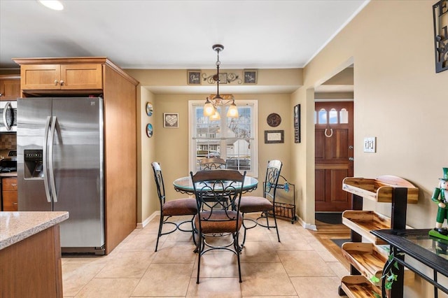 dining room with light tile patterned flooring and baseboards