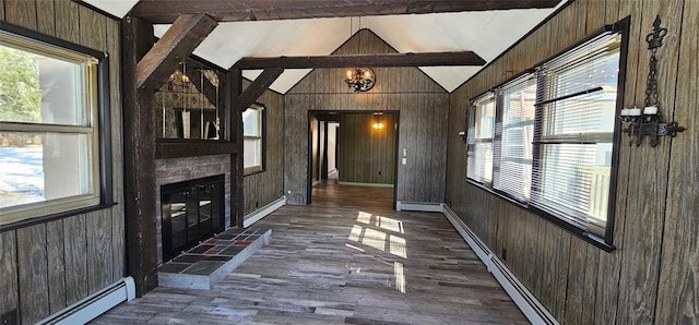 interior space with lofted ceiling, wood walls, a fireplace, and a baseboard heating unit