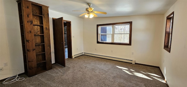 unfurnished bedroom with a baseboard heating unit, dark colored carpet, ceiling fan, and baseboards