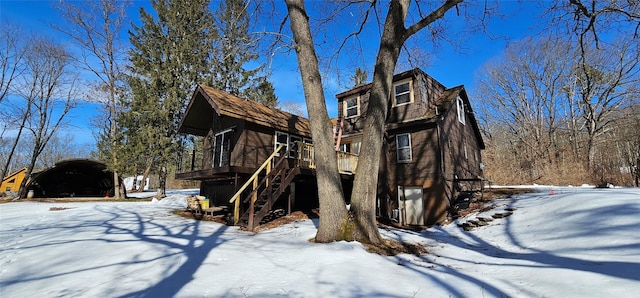 exterior space featuring stairs and a wooden deck