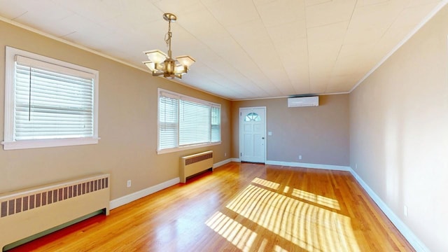 foyer entrance featuring an AC wall unit, crown molding, and radiator heating unit