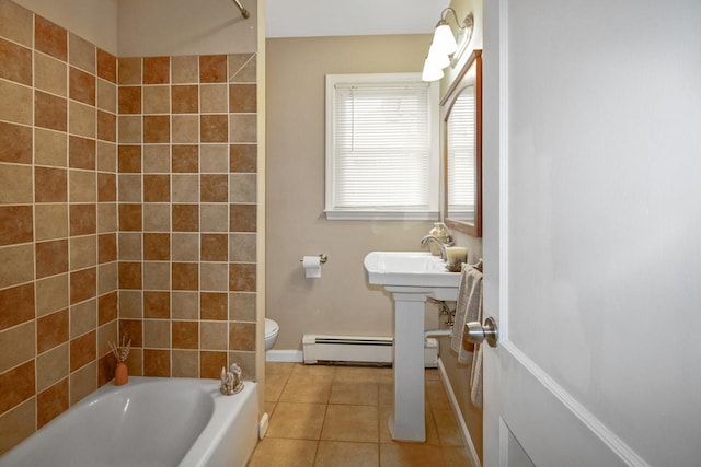 bathroom featuring toilet,  shower combination, tile patterned flooring, baseboard heating, and a sink