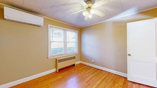 spare room with ornamental molding, light wood-type flooring, radiator heating unit, and a wall mounted AC