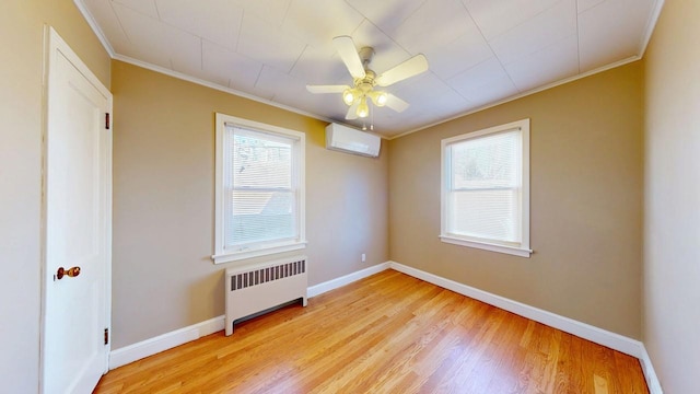 empty room with baseboards, light wood-style floors, ornamental molding, a wall mounted AC, and radiator heating unit