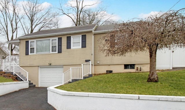 view of front of property featuring a garage, stairway, aphalt driveway, and a front yard