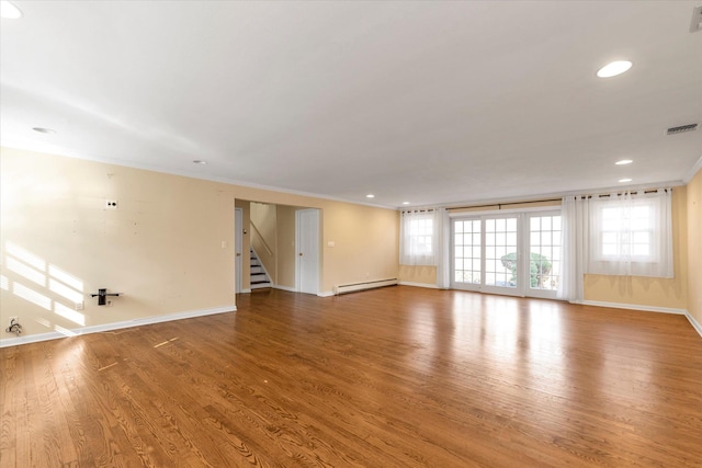 unfurnished living room with a baseboard radiator, visible vents, stairway, ornamental molding, and wood finished floors