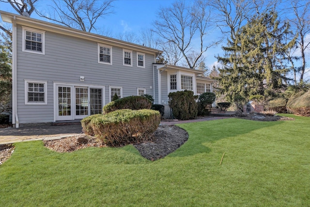 rear view of house featuring a yard and a patio area