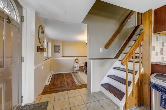 staircase featuring a baseboard radiator and tile patterned flooring