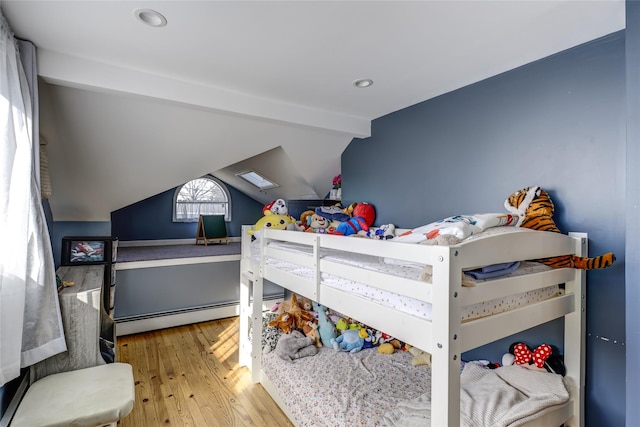 bedroom featuring vaulted ceiling with beams, a baseboard radiator, and wood finished floors