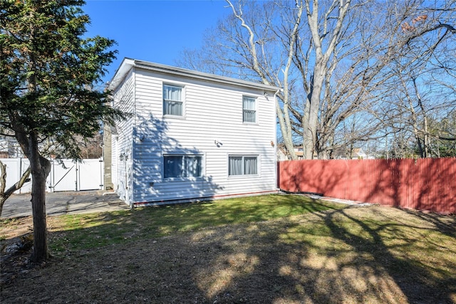 back of house with a yard and fence