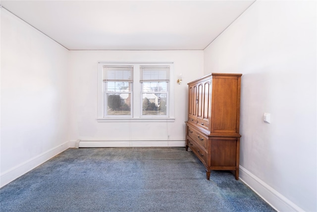 unfurnished bedroom featuring carpet floors, baseboards, and a baseboard heating unit