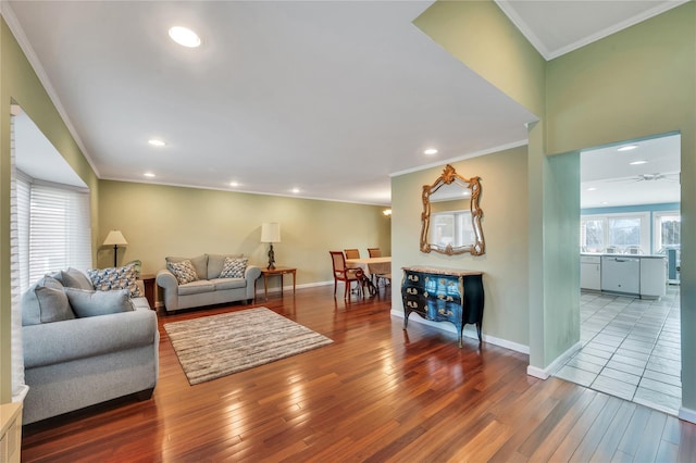 living area with crown molding, baseboards, wood finished floors, and recessed lighting