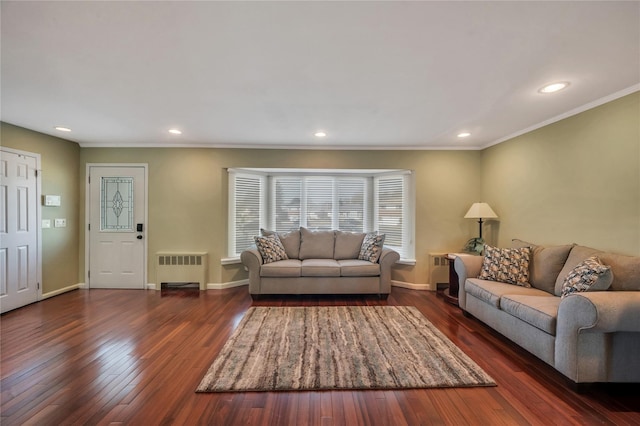 living area with crown molding, radiator heating unit, hardwood / wood-style flooring, and baseboards