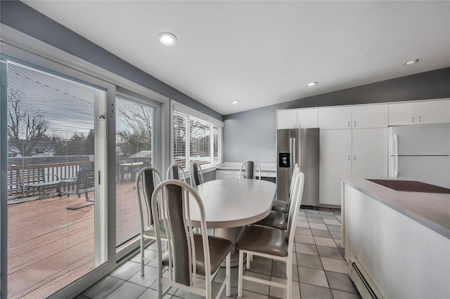 dining area with a baseboard heating unit, recessed lighting, vaulted ceiling, and light tile patterned floors