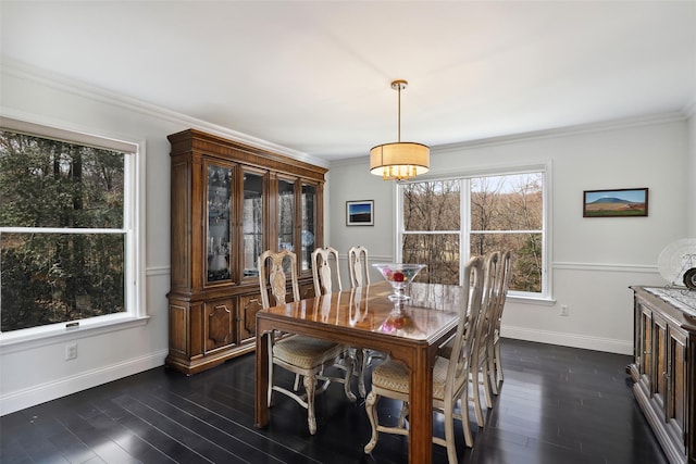 dining room featuring dark wood-style floors, ornamental molding, and baseboards