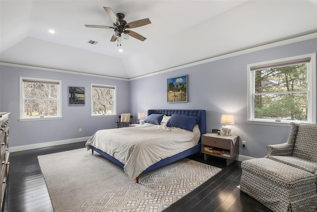 bedroom with vaulted ceiling, visible vents, dark wood finished floors, and baseboards