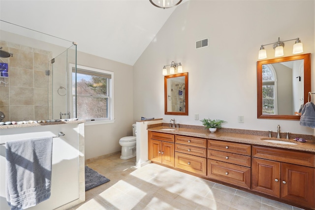 full bath with visible vents, a sink, a tile shower, and toilet