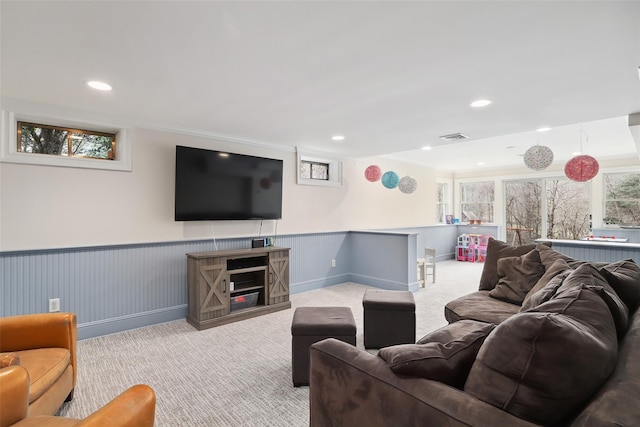 living room with a wainscoted wall, visible vents, carpet flooring, and recessed lighting