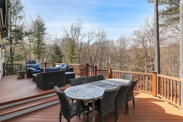 wooden deck with outdoor dining area, a grill, and outdoor lounge area