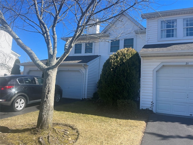 view of home's exterior featuring a garage and roof with shingles