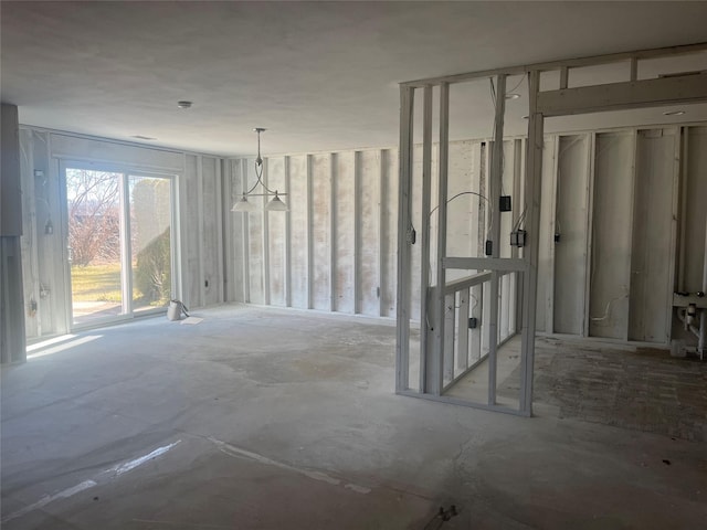 unfurnished dining area featuring concrete floors