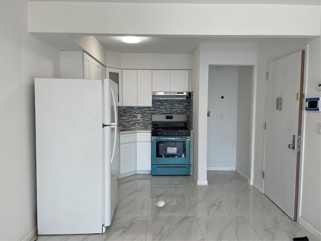 kitchen with freestanding refrigerator, stainless steel gas range, marble finish floor, under cabinet range hood, and white cabinetry