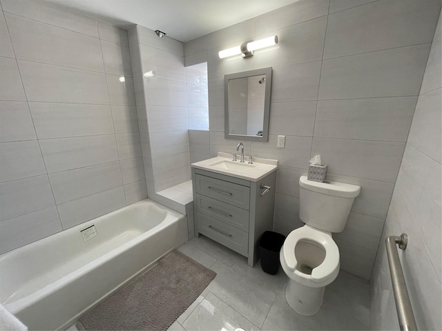 full bath featuring toilet, vanity, and tile walls