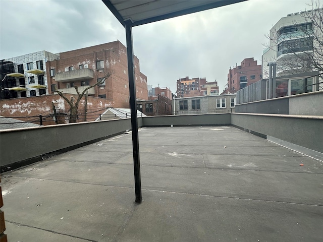 view of tennis court with a view of city