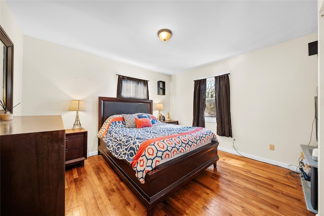 bedroom featuring baseboards and hardwood / wood-style floors