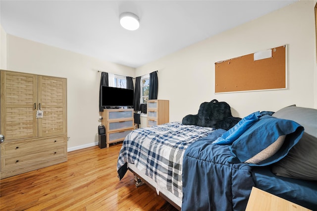 bedroom featuring light wood-type flooring and baseboards