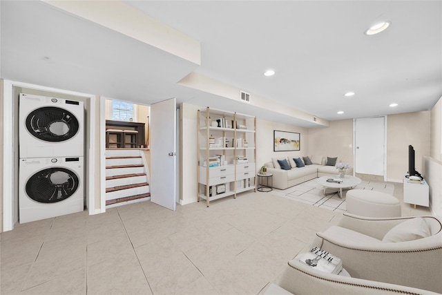 living area with stacked washer / drying machine, recessed lighting, visible vents, stairway, and light tile patterned flooring