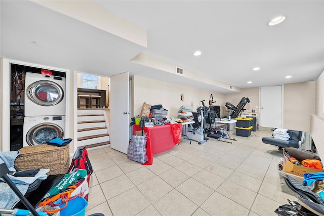 interior space featuring stacked washer and dryer, light tile patterned flooring, visible vents, and recessed lighting