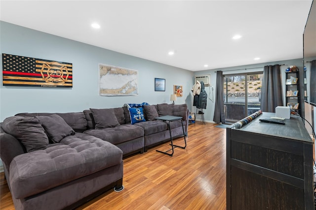 living area with light wood finished floors and recessed lighting