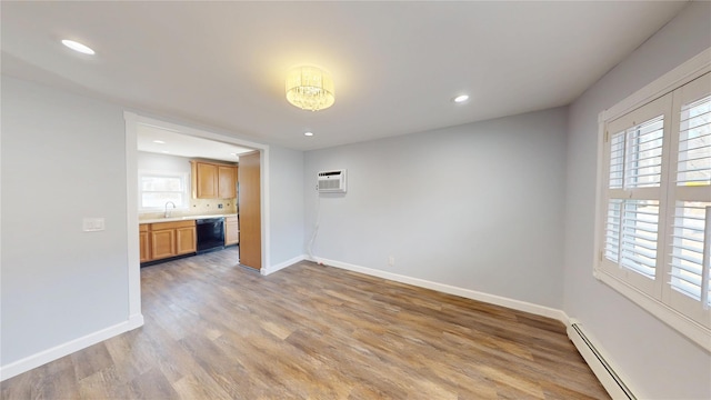 unfurnished room featuring light wood-style floors, baseboards, plenty of natural light, and baseboard heating