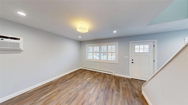 foyer entrance featuring a baseboard radiator, a wall unit AC, recessed lighting, wood finished floors, and baseboards