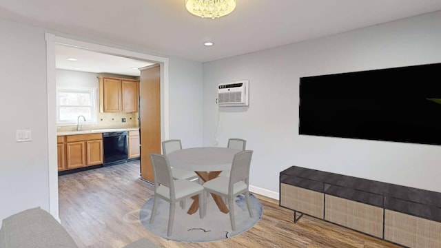 dining room with light wood finished floors, a wall mounted air conditioner, recessed lighting, and baseboards