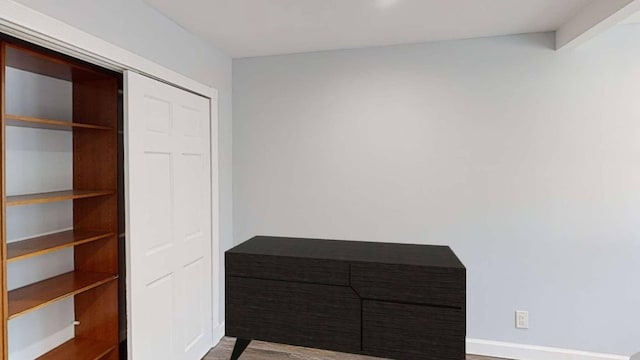 unfurnished bedroom with a closet and wood finished floors