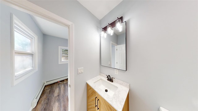 bathroom featuring a baseboard radiator, wood finished floors, and vanity