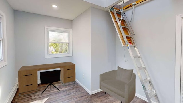 home office with recessed lighting, wood finished floors, a baseboard radiator, and baseboards