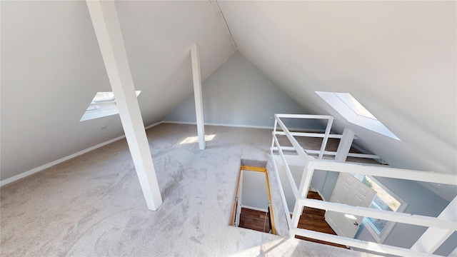 bonus room featuring lofted ceiling with skylight and baseboards