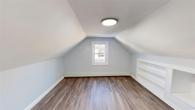 bonus room with baseboards, a baseboard heating unit, vaulted ceiling, and wood finished floors