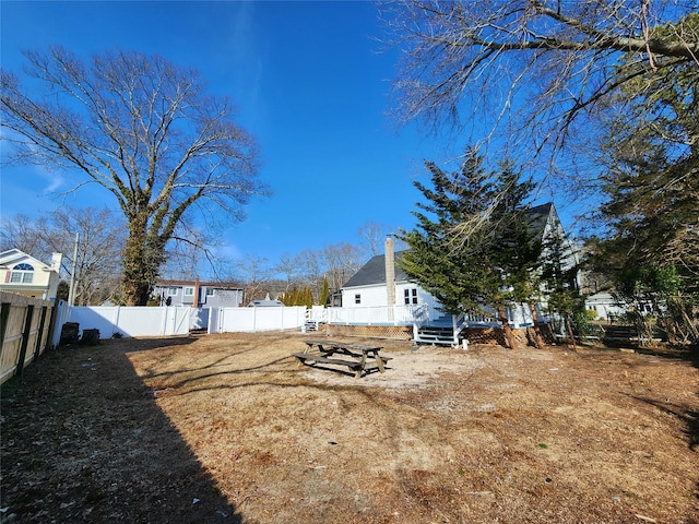 view of yard featuring a fenced backyard and a wooden deck