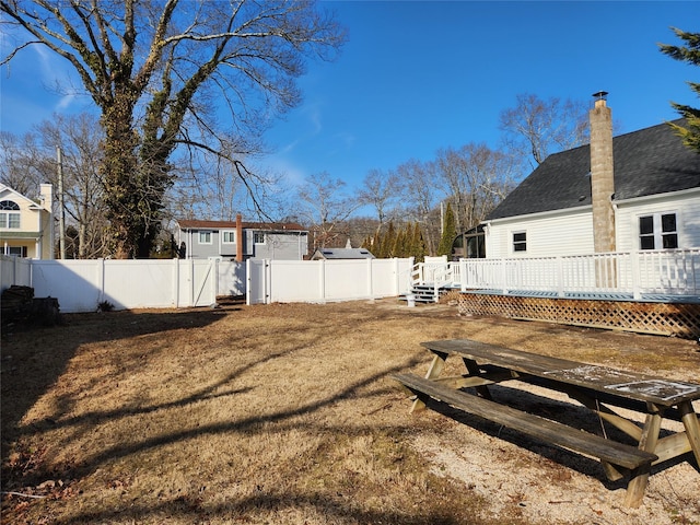 view of yard featuring a fenced backyard, a gate, and a wooden deck