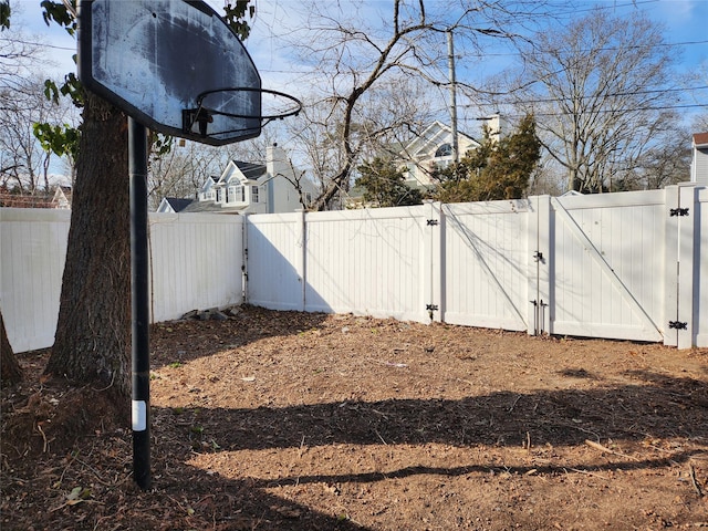 view of yard featuring a fenced backyard and a gate