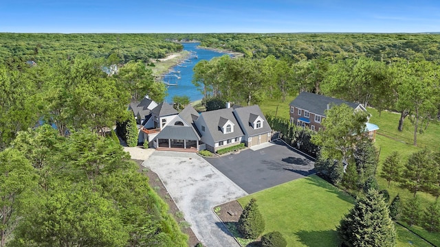 bird's eye view with a wooded view and a water view