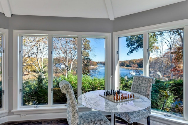 sunroom featuring a water view and a wealth of natural light