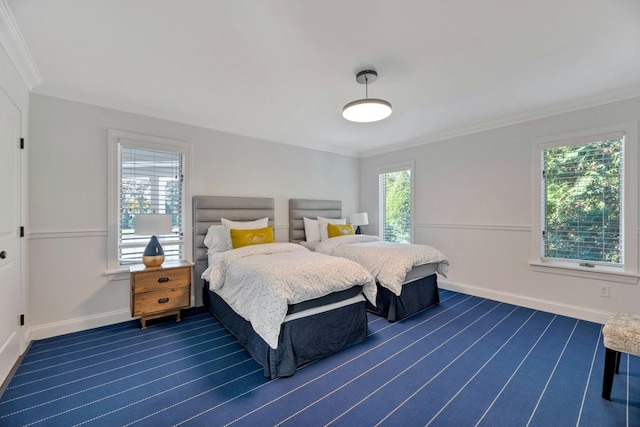 bedroom with crown molding, multiple windows, baseboards, and dark wood-style flooring