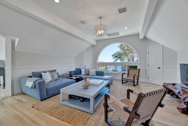 living area featuring lofted ceiling with beams, visible vents, a notable chandelier, and wood finished floors