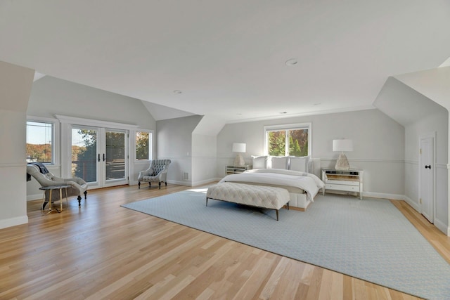 bedroom featuring french doors, light wood-style floors, access to exterior, and vaulted ceiling